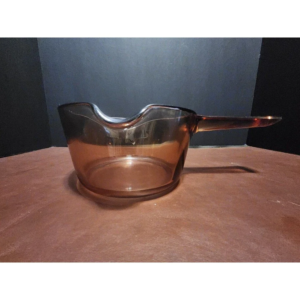 This item appears to be a vintage Corning Visions amber glass 1-liter...